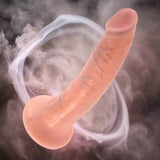 Realistic silicone model of a penis on a white background